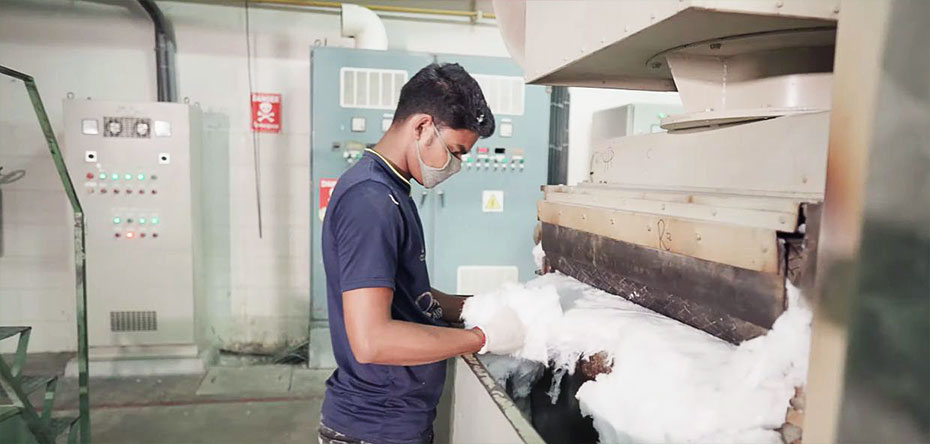 Worker in a garment recycle center